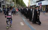 De processie van hoogleraren van de Campus Fryslân door de Leeuwarder binnenstad trok veel bekijks. FOTO HOGE NOORDEN/JAAP SCHAAF