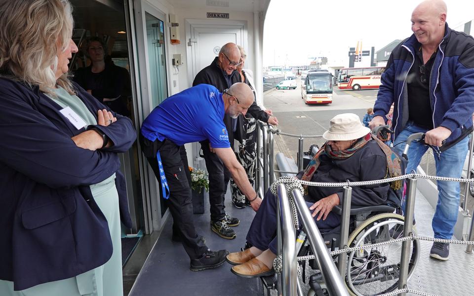 Vrijwillgers helpen de bewoners aan boord.