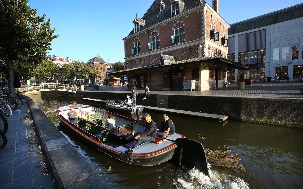 Schippers Zweitse Pietersen (l.) en Willem Barendrecht van Stichting Praamvaren passeren de Waag in Leeuwarden. Vanwege coronaregels zijn er nog maar een paar bankjes over in de boot. FOTO NIELS WESTRA Schippers Zweitse Pietersen (l.) en Willem Barendrecht van Stichting Praamvaren passeren de Waag in Leeuwarden. Vanwege coronaregels zijn er nog maar een paar bankjes over in de boot. FOTO NIELS WESTRA