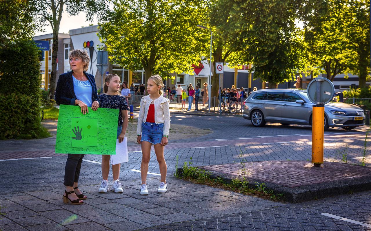 Reza (m) en Maud (r) op de middenberm van de gevaarlijke kruising met wethouder Mirjam Bakker. Op de achtergrond de Zwetteschool Reza (m) en Maud (r) op de middenberm van de gevaarlijke kruising met wethouder Mirjam Bakker. Op de achtergrond de Zwetteschool