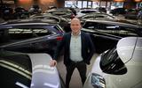 Directeur Johan Tuinstra temidden van tweedehands auto's in de showroom van Auto Synyco in Franeker.