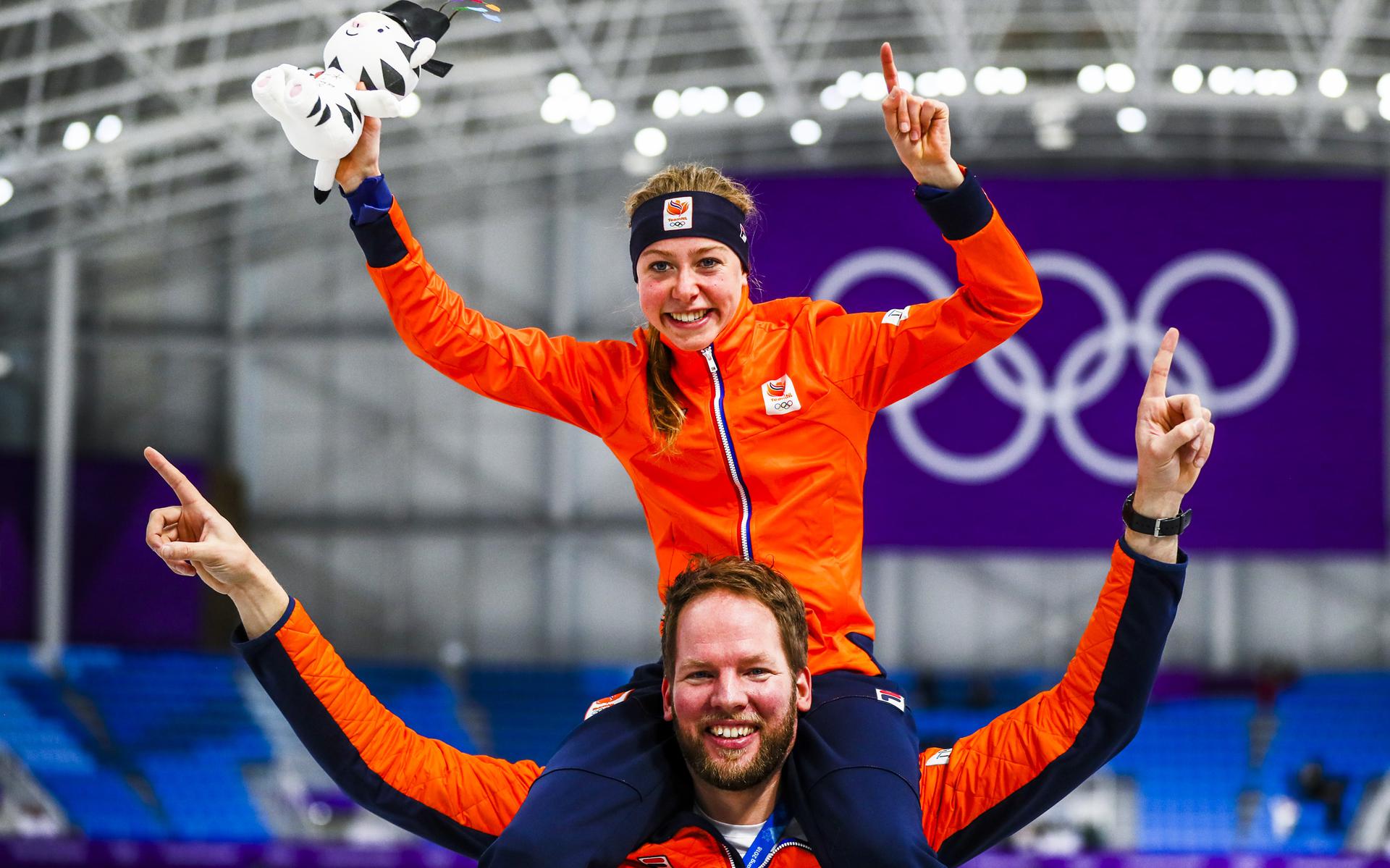 Op de schouders van coach Remmelt Eldering viert Esmee Visser in 2018 de olympische titel op de 5 kilometer.