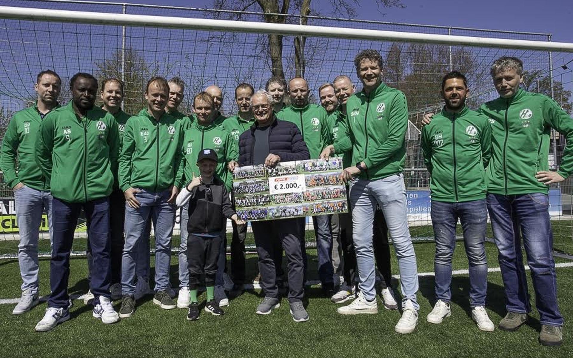 ’t Oud Vijfde van Heerenveense Boys overhandigt de cheque aan Foppe de Haan.