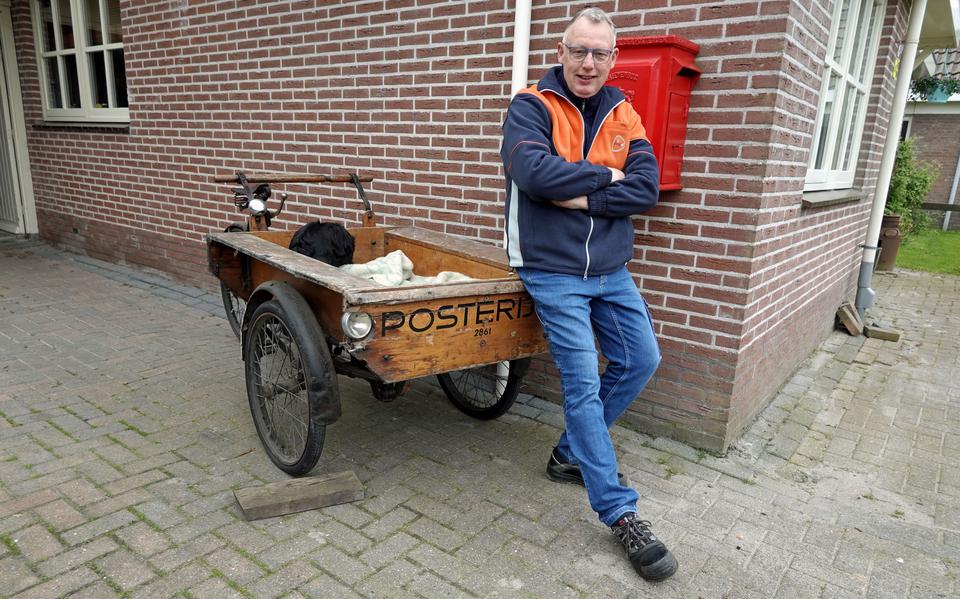 Onno Ebbendorf, leunend op een oude postkar voor een oude brievenbus. Foto Brenda van Olphen