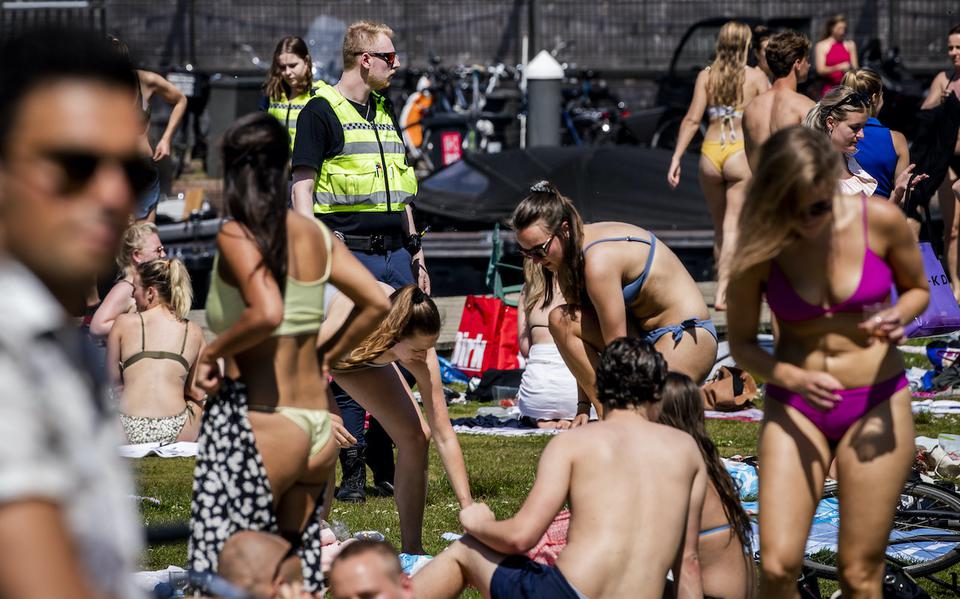 Handhavers en politie ontruimen Park Somerlust in Amsterdam vanwege de te grote drukte. 
