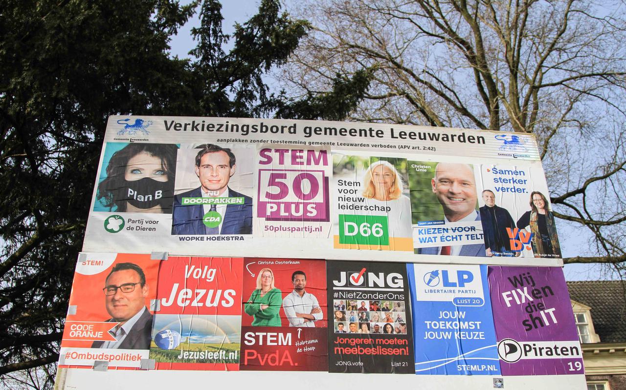 Een verkiezingsbord in Leeuwarden met posters van de politieke partijen voor de Tweede Kamerverkiezingen op woensdag 17 maart. FOTO ANTON KAPPERS